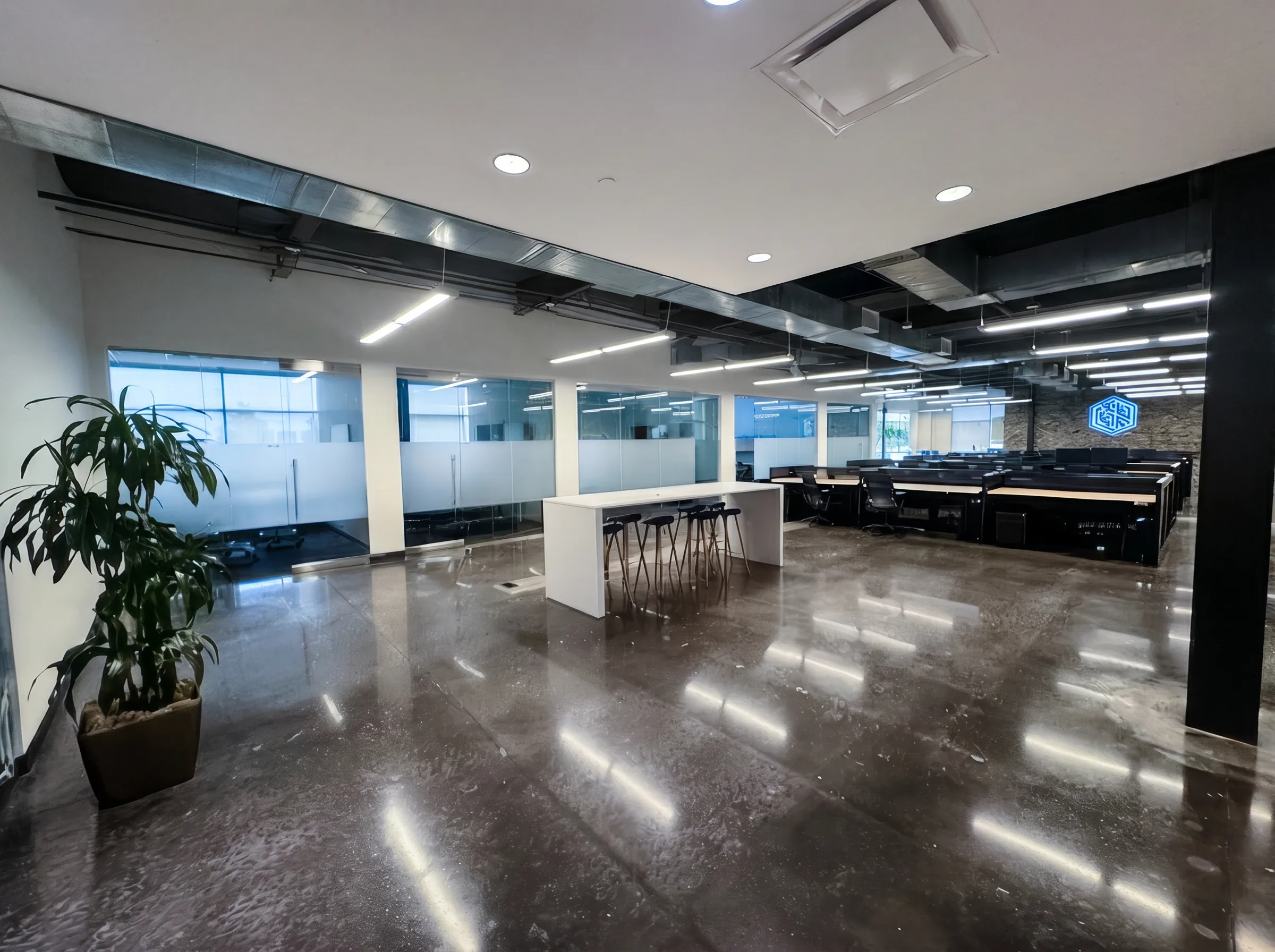Bright open workspace with glass-front offices on the first floor